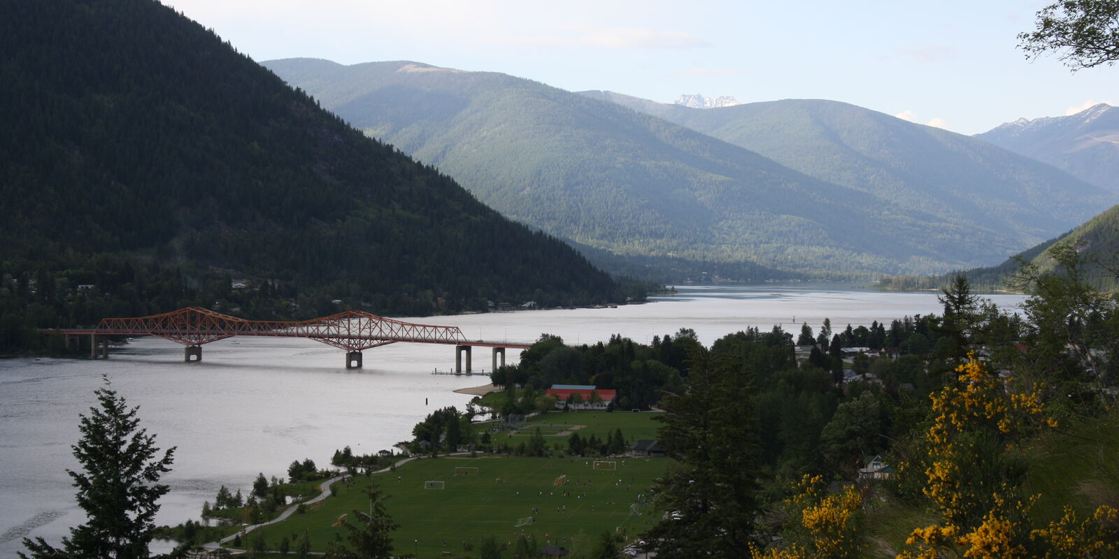 Nelson, BC on the West Arm of Kootenay Lake, with the orange Big Orange Bridge and forested mountains